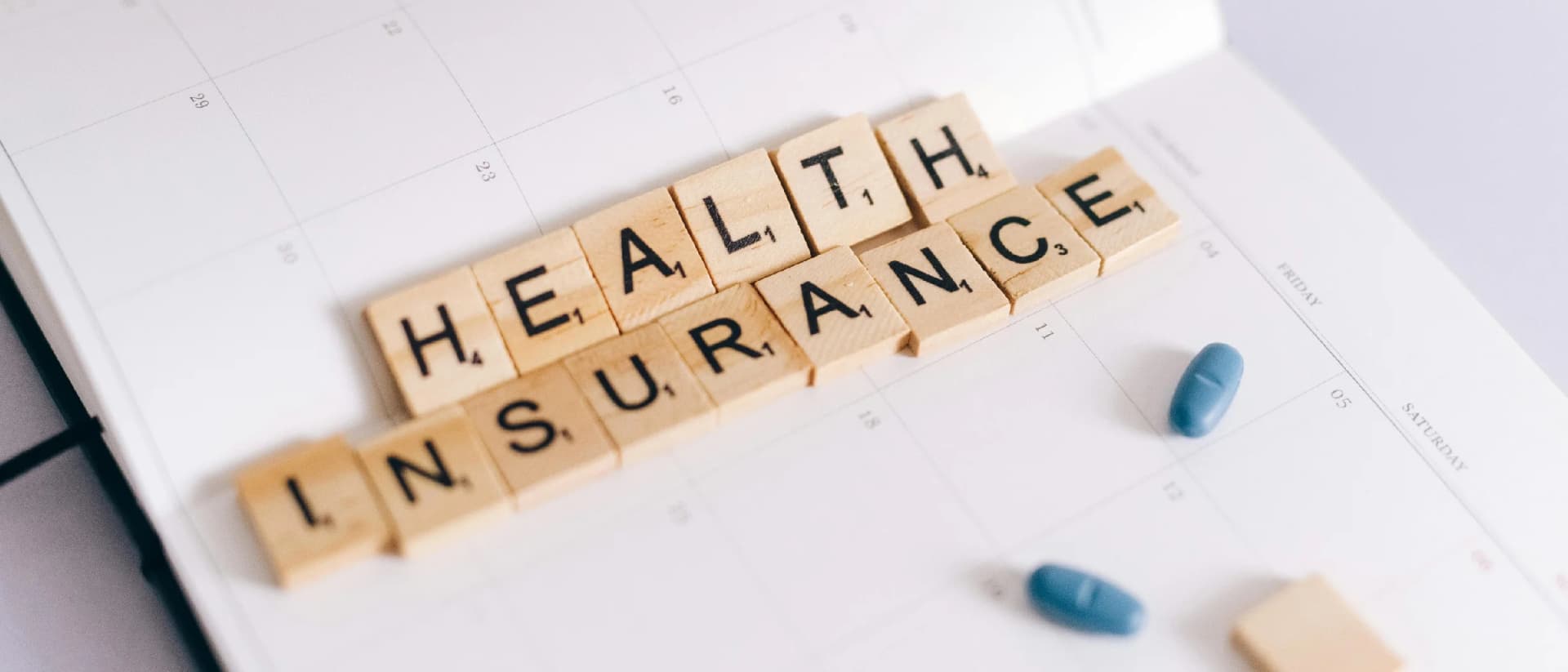 Health insurance scrabble tiles with pills