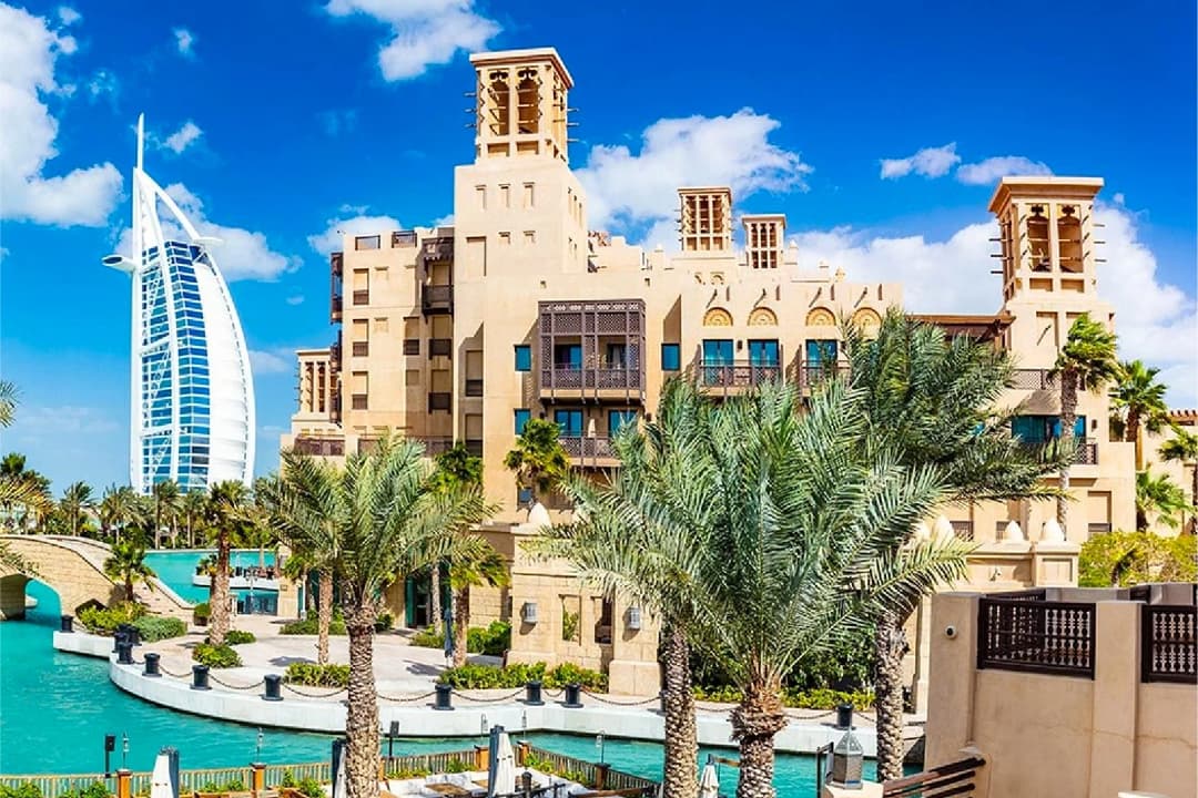 Modern apartment complex with city street and Burj Al Arab