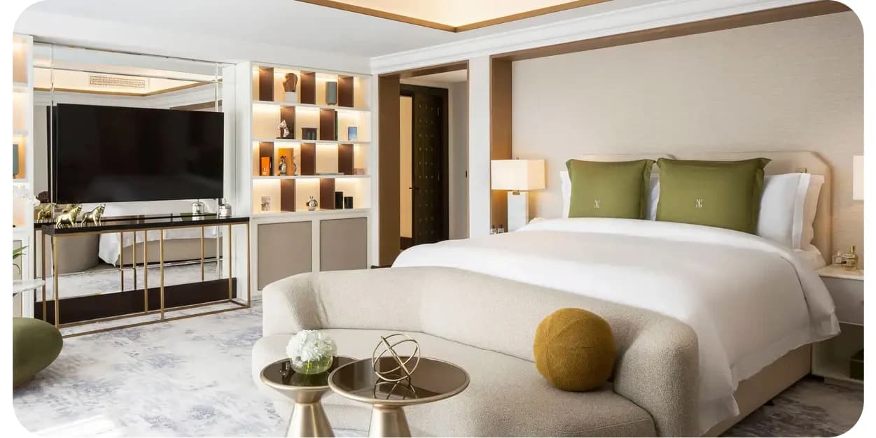 A modern hotel room with a bed and a TV