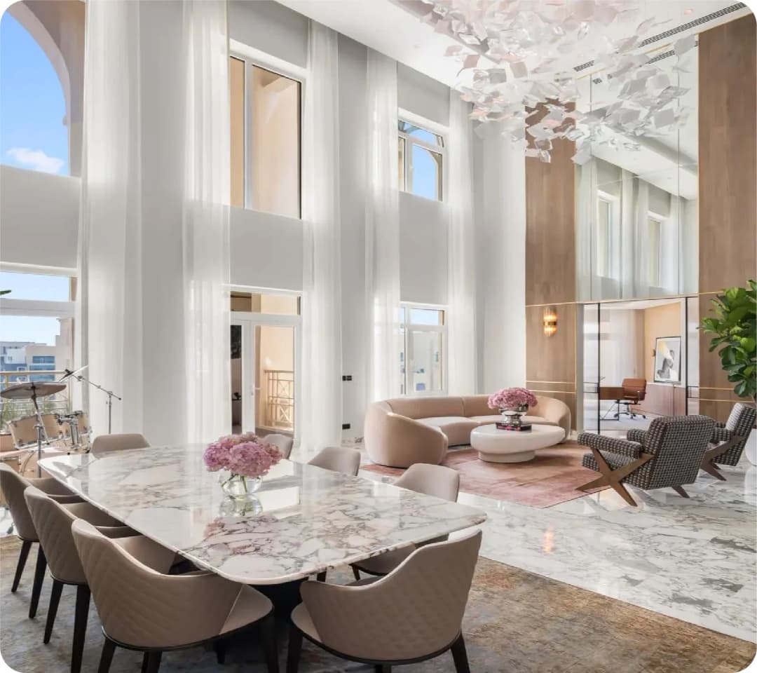 Marie's Corner Dining Table in a modern, high-ceiling room