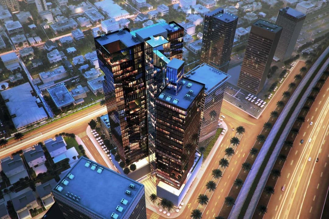 Aerial view of high-rise towers in city at night