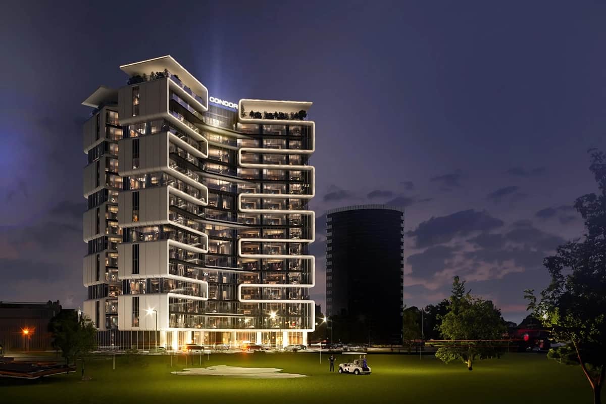 Sleek illuminated building with golf course at night