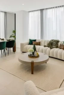 Modern living room with a comfortable couch, round coffee table, and a dining table