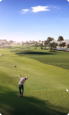 Golfer playing in the 18th hole golf course of emaar, Dubai