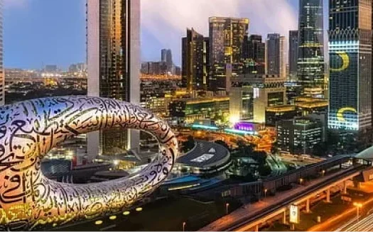 Futuristic Museum of the Future in Dubai with illuminated skyscrapers in the background.