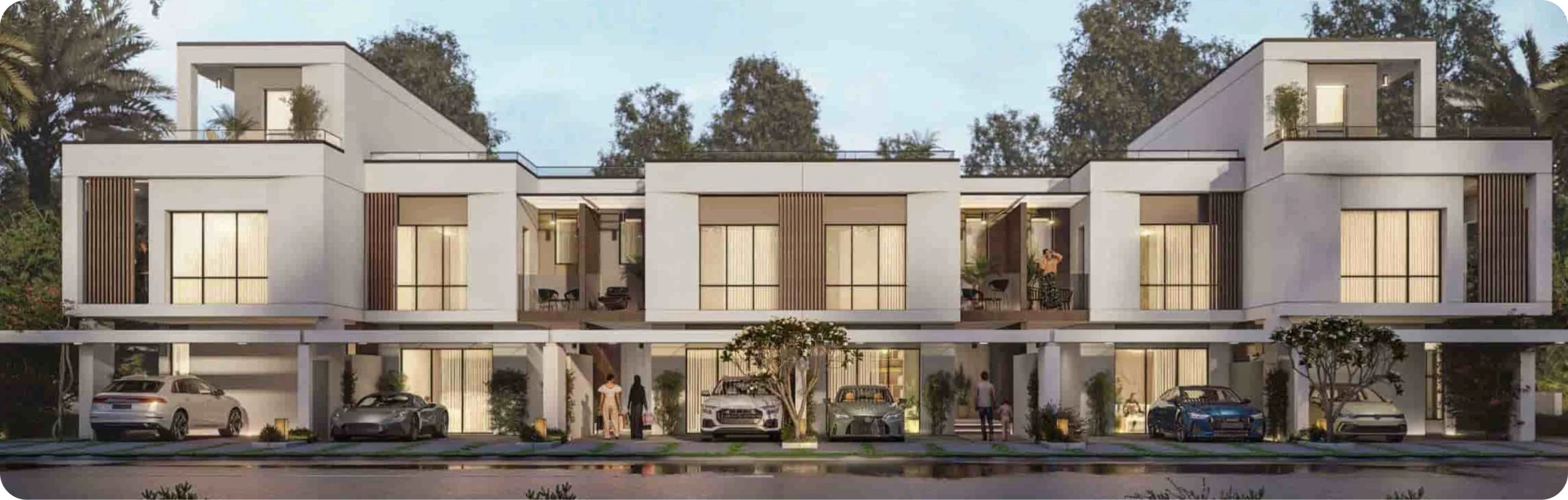 Modern townhouses with contemporary architecture and lush greenery in a serene setting.